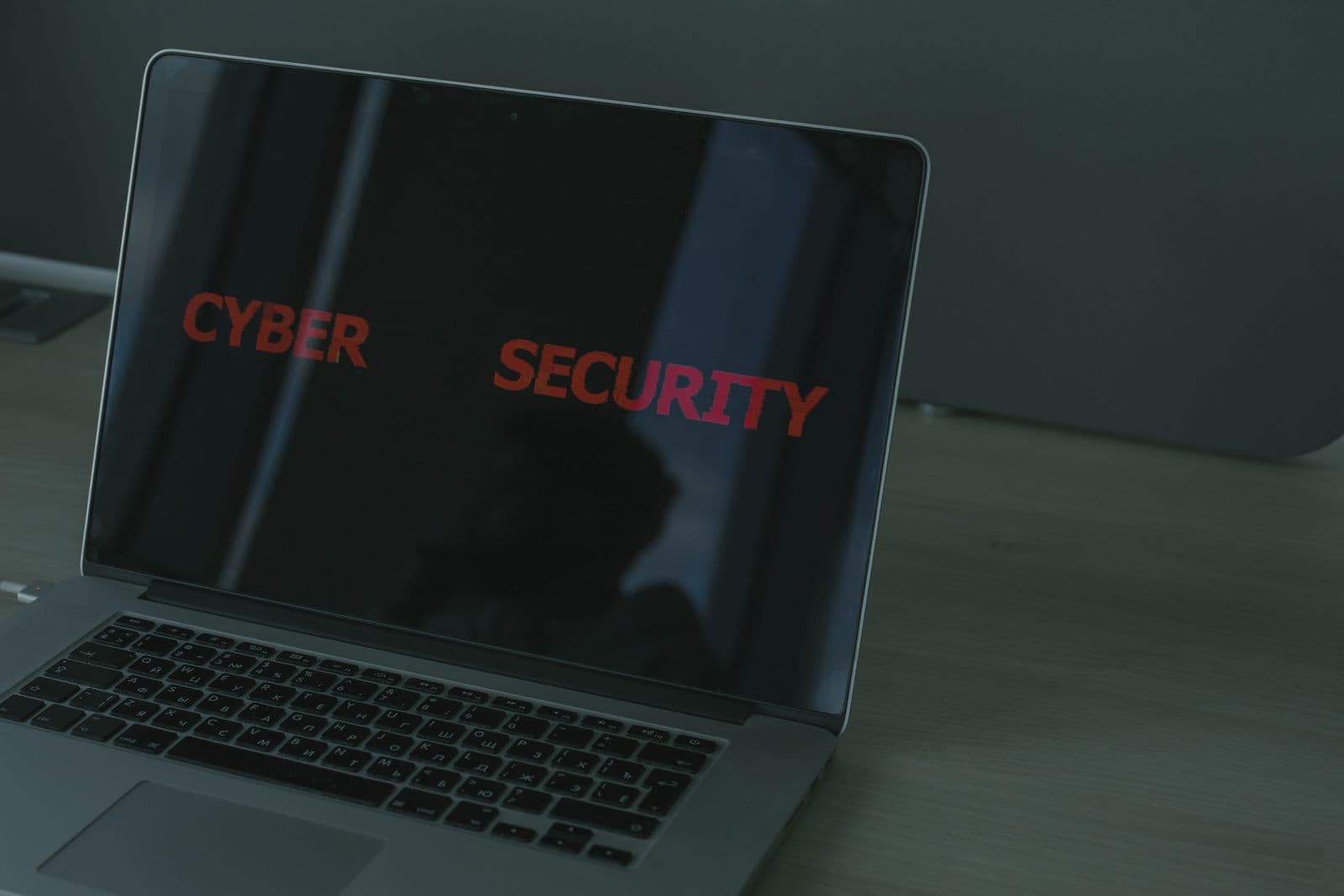 A laptop screen displaying a cyber security dashboard